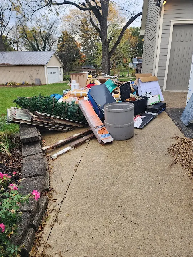Dumpster being loaded with debris for Roofing Dumpster Rental in Wendell